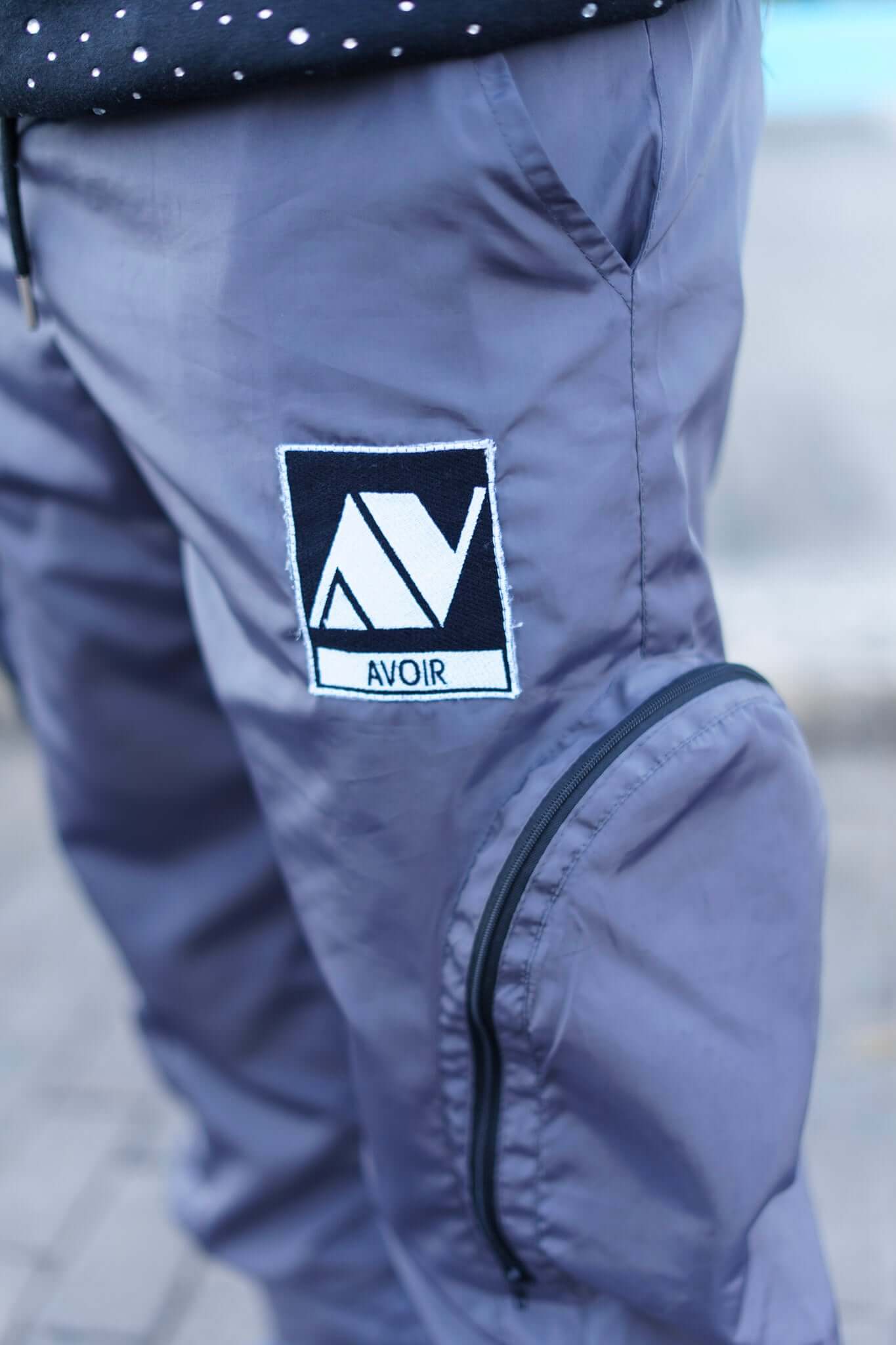Parachute Cargo Pants | Avoir Couture featuring signature Avoir logo on lightweight nylon fabric close-up.