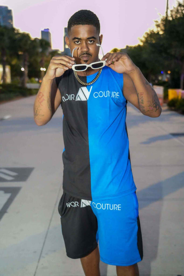 Man wearing 2pc Swim and Lounge Set in black and blue two-tone dry fit material outdoors