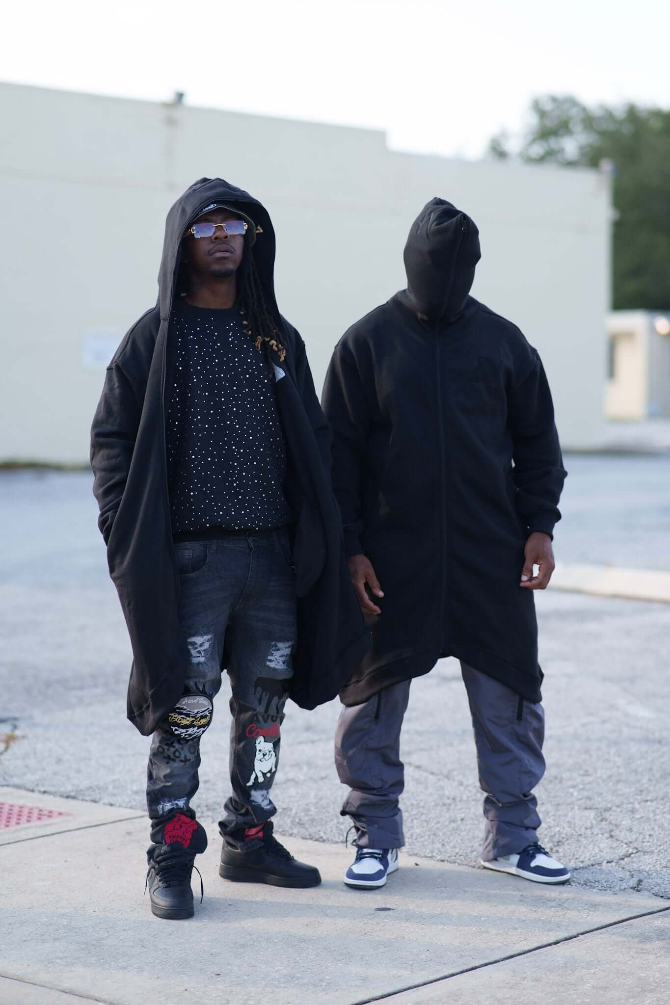 Marathon Hoodie | Avoir Fall Season worn by two models showcasing bold streetwear style and extended length design.