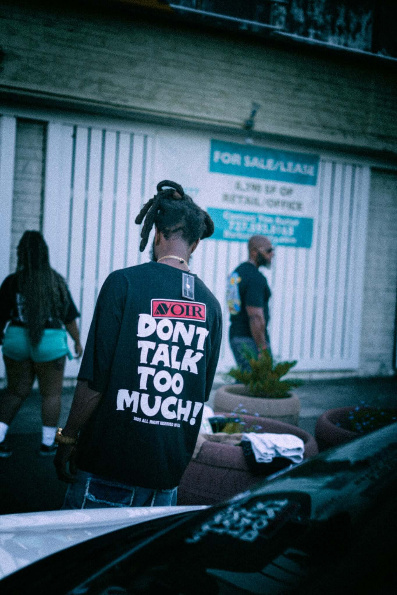 Say Less Tee by Avoir Couture – Oversized Graphic Streetwear featuring bold 'DON'T TALK TOO MUCH!' graphic on back.
