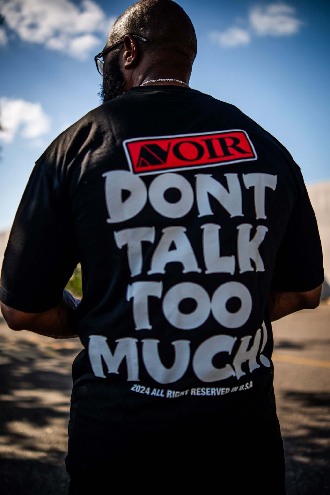 Say Less Tee by Avoir Couture – Oversized Graphic Streetwear featuring bold 'DON'T TALK TOO MUCH' graphic on back.